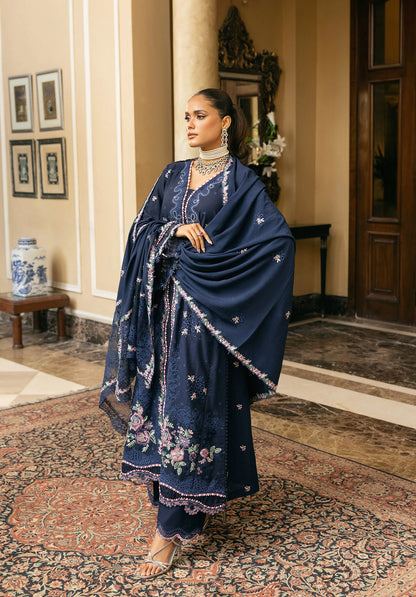 Woman in a navy blue traditional outfit with floral patterns in ELAF LUXURY WINTER.
