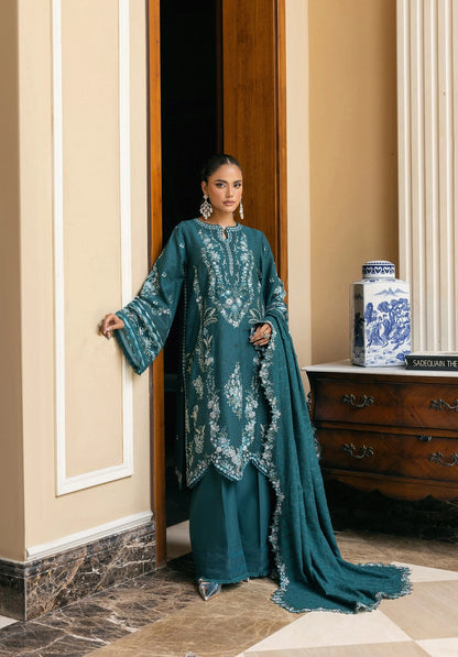 Woman in a teal embroidered outfit standing in a doorway in elaf LUXURY WINTER '25