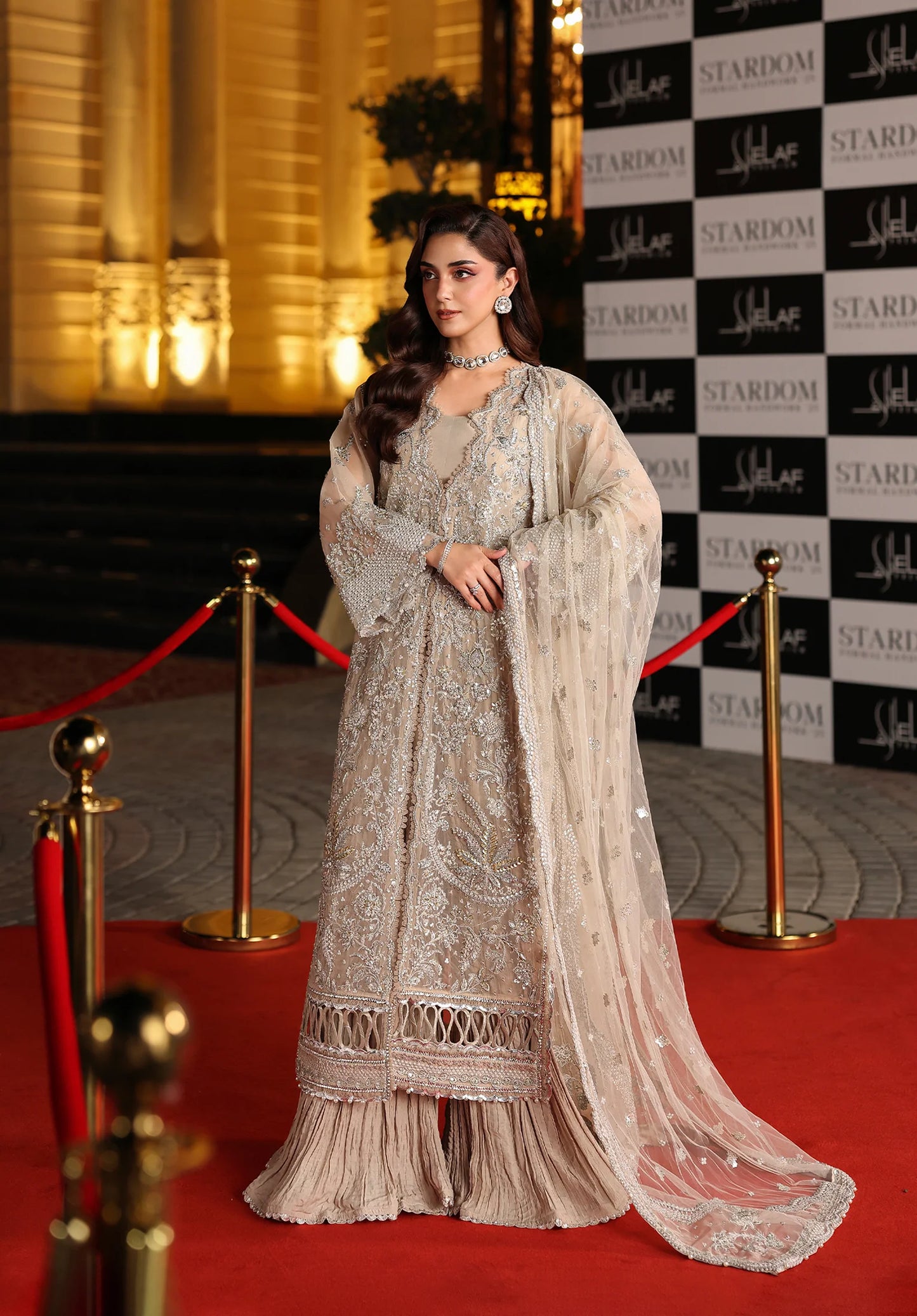 Woman in an elegant dress on a red carpet with Elaf Stardom Handwork.