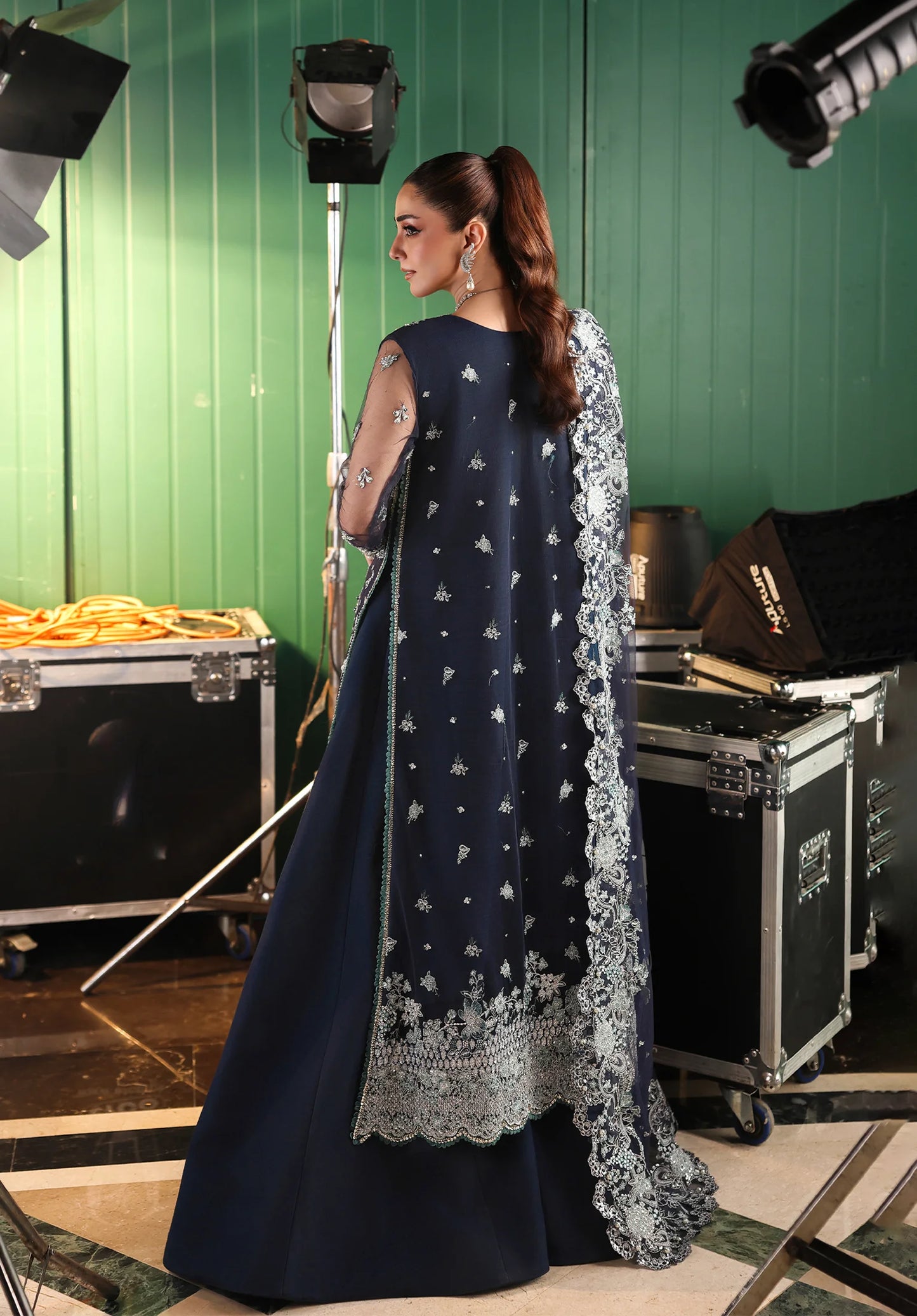 Woman in a dark blue traditional outfit with silver embroidery using Elaf Stardom Handwork
