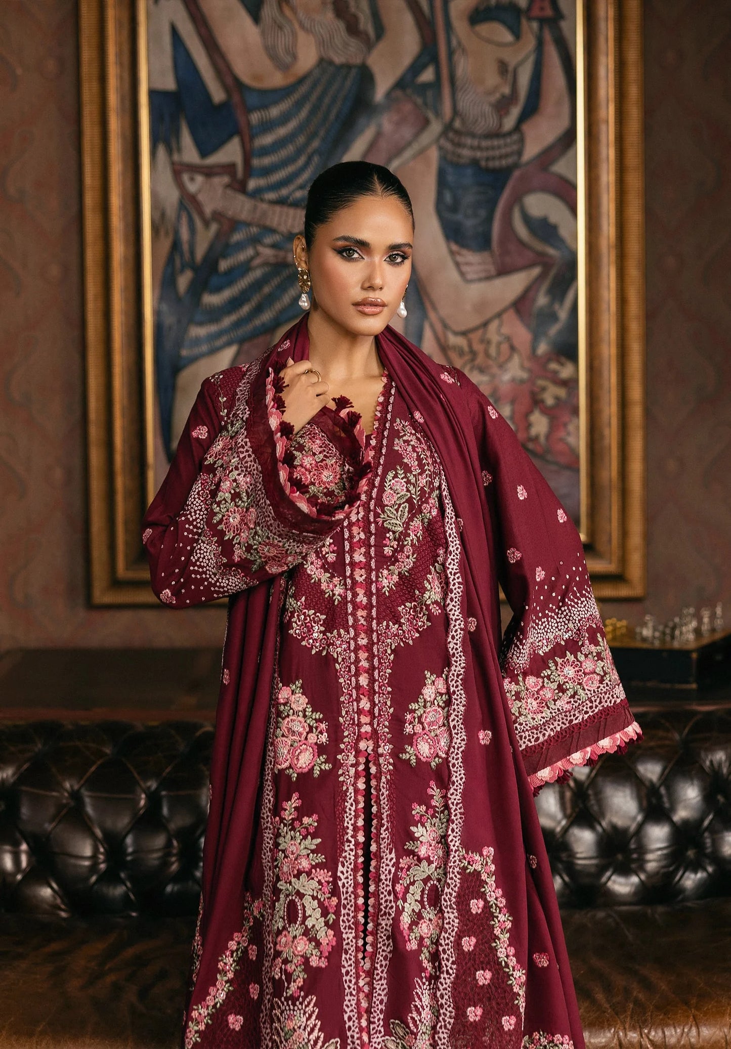 Woman wearing a burgundy embroidered traditional outfit in an ornate room from elaf LUXURY WINTER '25
